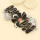 Dandy | Armband | Taratata - Florales Armband mit Blütenmotiv und Goldenen Blattmuster auf Schwarz Silberne Details